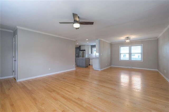 5917 W 101st Ter, Overland Park, KS 66207 - unfurnished living room featuring a ceiling fan, light wood finished floors, ornamental molding, and recessed lighting