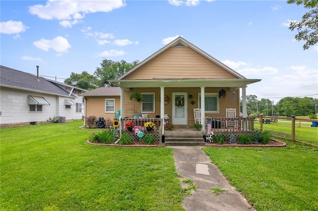 302 W 4th St, Waverly, KS 66871 - bungalow-style home featuring a front lawn, covered porch, and central AC unit
