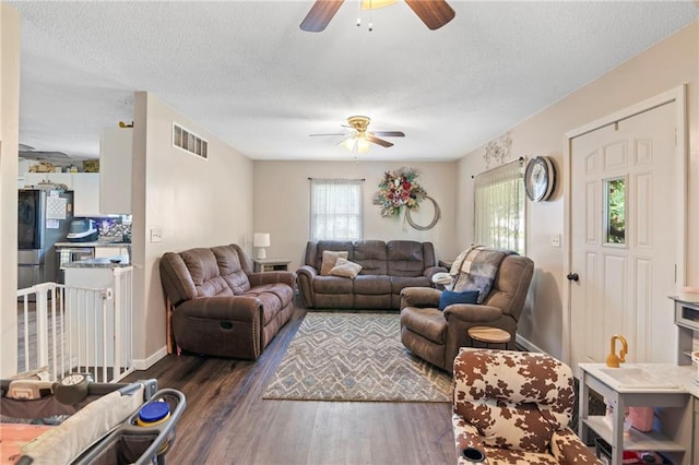 302 W 4th St, Waverly, KS 66871 - living area featuring ceiling fan, wood finished floors, plenty of natural light, and a textured ceiling