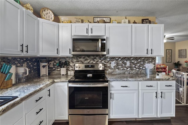 302 W 4th St, Waverly, KS 66871 - kitchen with stainless steel appliances, white cabinetry, a textured ceiling, decorative backsplash, and ceiling fan