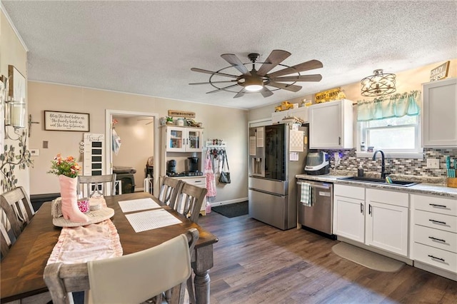 302 W 4th St, Waverly, KS 66871 - kitchen featuring stainless steel appliances, a sink, a textured ceiling, ceiling fan, and dark wood-style floors