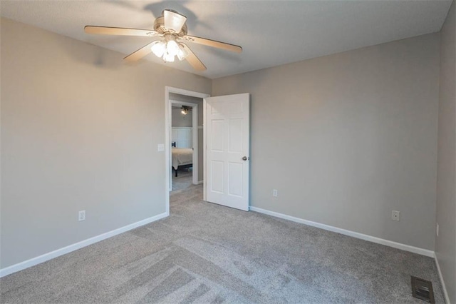 7503 N Lewis Ave, Kansas City, MO 64158 - carpeted empty room with a ceiling fan and baseboards