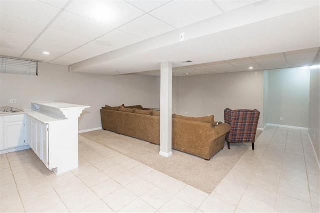 7503 N Lewis Ave, Kansas City, MO 64158 - finished below grade area featuring a drop ceiling, light tile patterned floors, and recessed lighting