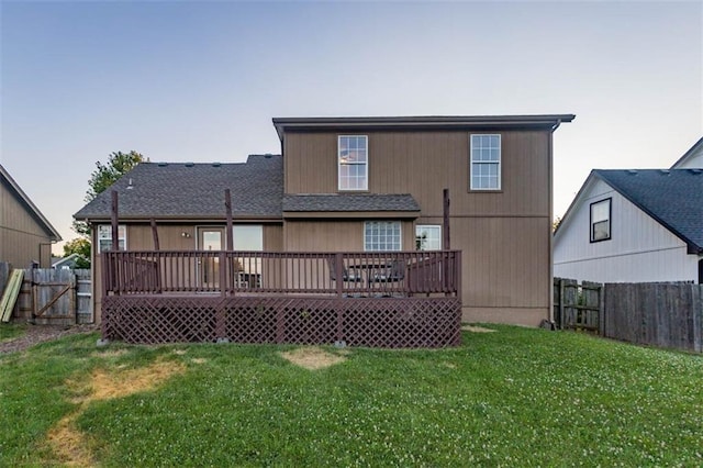 7503 N Lewis Ave, Kansas City, MO 64158 - back of property with a wooden deck, a fenced backyard, roof with shingles, and a gate
