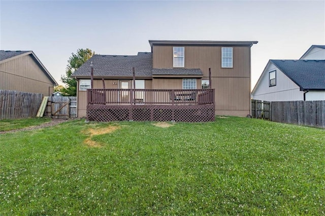 7503 N Lewis Ave, Kansas City, MO 64158 - back of property with a fenced backyard, a wooden deck, and a gate