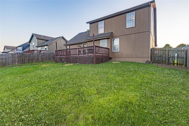 7503 N Lewis Ave, Kansas City, MO 64158 - rear view of house with a wooden deck and a fenced backyard