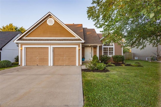 7503 N Lewis Ave, Kansas City, MO 64158 - traditional-style home with driveway, a front yard, an attached garage, and a shingled roof