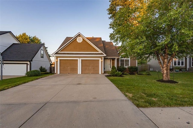 7503 N Lewis Ave, Kansas City, MO 64158 - traditional-style home featuring a front yard, driveway, and a garage