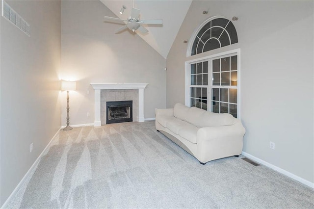 7503 N Lewis Ave, Kansas City, MO 64158 - living room with carpet, high vaulted ceiling, a ceiling fan, and a tile fireplace