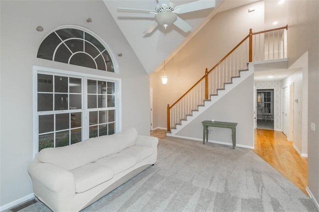 7503 N Lewis Ave, Kansas City, MO 64158 - sitting room featuring high vaulted ceiling, stairs, a ceiling fan, and carpet flooring