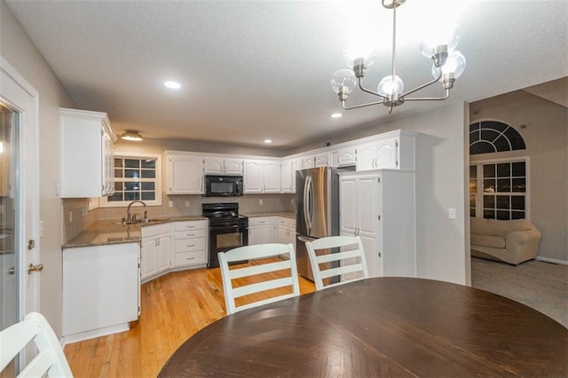 7503 N Lewis Ave, Kansas City, MO 64158 - dining area with a chandelier, recessed lighting, light wood finished floors, and a textured ceiling