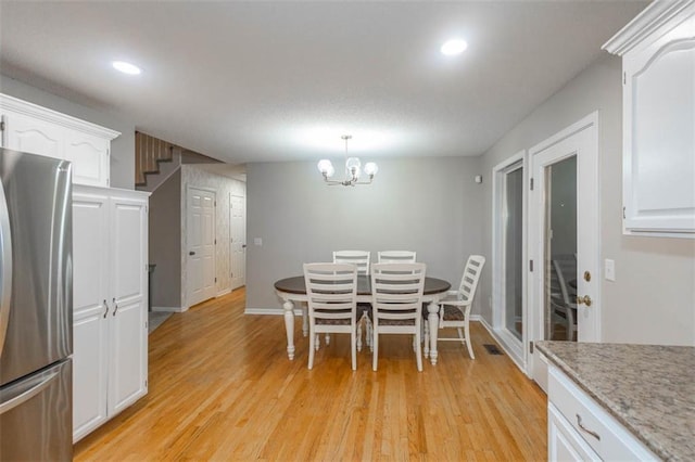 7503 N Lewis Ave, Kansas City, MO 64158 - dining space with light wood-style floors, recessed lighting, and a chandelier