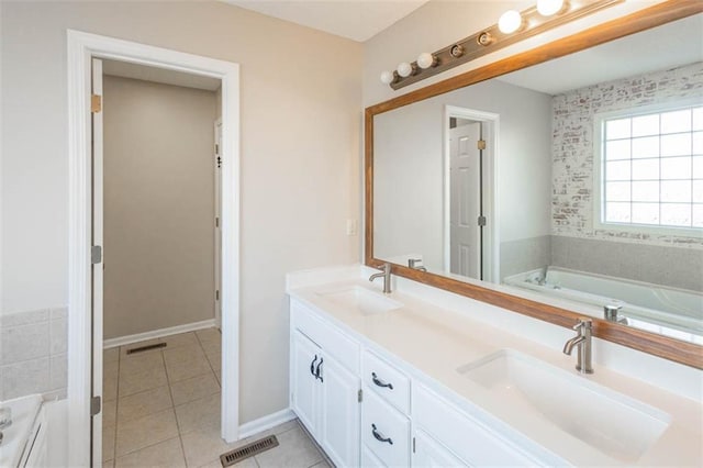 7503 N Lewis Ave, Kansas City, MO 64158 - bathroom with a garden tub, double vanity, and tile patterned flooring