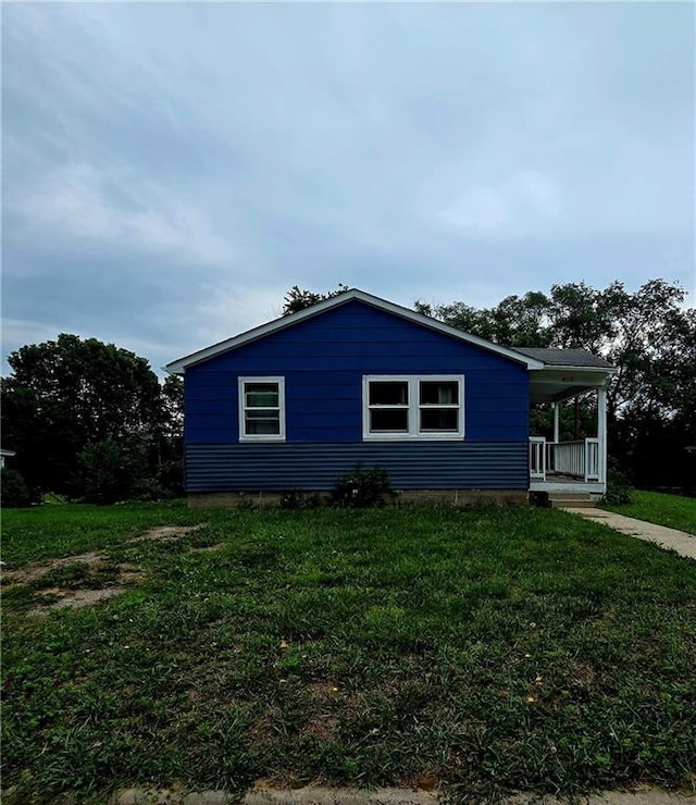 403 S Washington St, Rock Port, MO 64482 - view of home's exterior featuring covered porch and a lawn