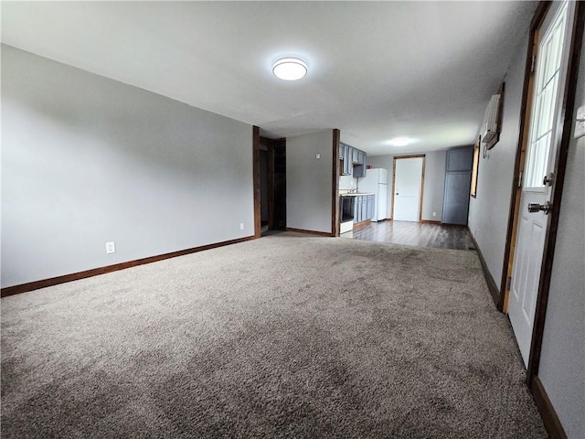 403 S Washington St, Rock Port, MO 64482 - unfurnished living room featuring carpet and baseboards