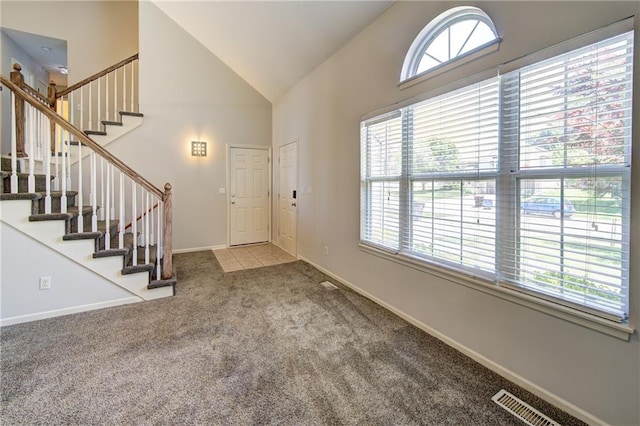 610 SE Joel Ave, Lees Summit, MO 64063 - carpeted entryway featuring plenty of natural light, high vaulted ceiling, and stairway