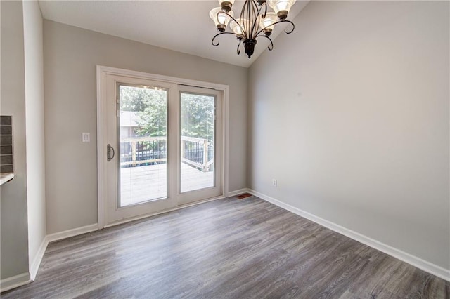 610 SE Joel Ave, Lees Summit, MO 64063 - unfurnished dining area featuring wood finished floors, a chandelier, and vaulted ceiling