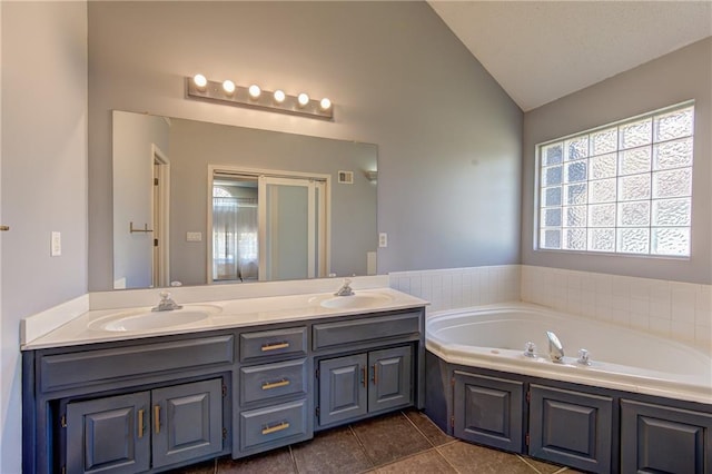 610 SE Joel Ave, Lees Summit, MO 64063 - bathroom featuring vaulted ceiling, double vanity, a garden tub, and tile patterned flooring