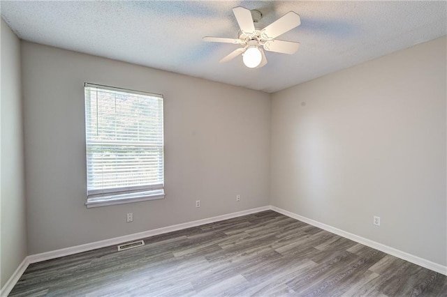 610 SE Joel Ave, Lees Summit, MO 64063 - unfurnished room with wood finished floors, a textured ceiling, and ceiling fan