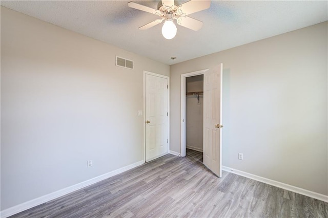610 SE Joel Ave, Lees Summit, MO 64063 - unfurnished bedroom with wood finished floors, a closet, and ceiling fan