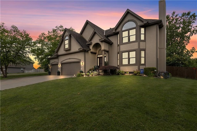 4022 SW Flintrock Dr, Lees Summit, MO 64082 - view of front of home with driveway, stucco siding, an attached garage, and a chimney