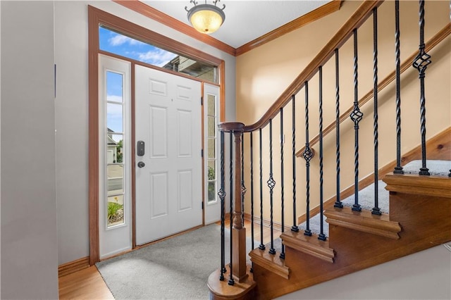 4022 SW Flintrock Dr, Lees Summit, MO 64082 - entryway featuring crown molding, baseboards, stairs, and wood finished floors