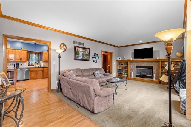 4022 SW Flintrock Dr, Lees Summit, MO 64082 - living area with crown molding, light wood-type flooring, a fireplace, recessed lighting, and baseboards