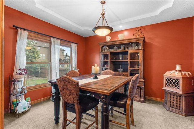 4022 SW Flintrock Dr, Lees Summit, MO 64082 - dining space with light colored carpet, a tray ceiling, and baseboards