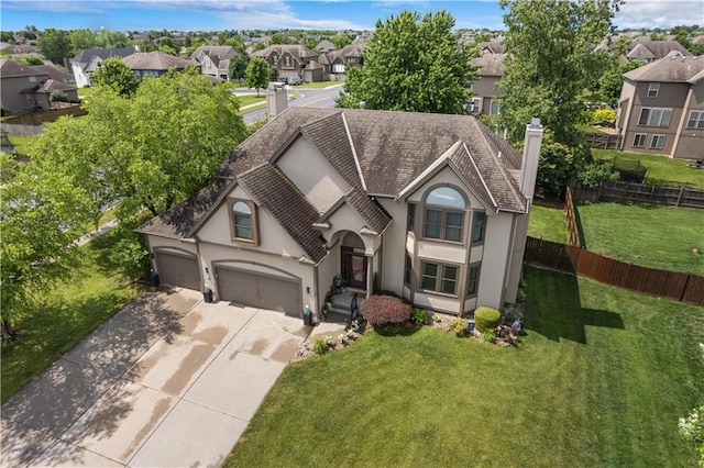 4022 SW Flintrock Dr, Lees Summit, MO 64082 - view of front facade featuring stucco siding, a residential view, a chimney, concrete driveway, and a garage