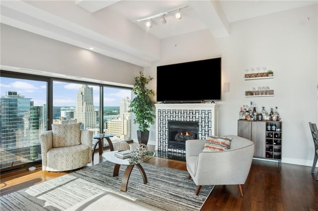 1101 Walnut St Unit 1809, Kansas City, MO 64106 - living area with a tile fireplace, wood finished floors, rail lighting, and baseboards