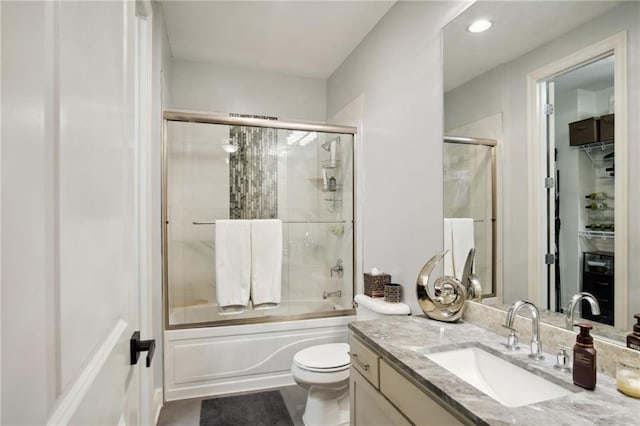 1101 Walnut St Unit 1809, Kansas City, MO 64106 - full bath featuring vanity, combined bath / shower with glass door, toilet, and recessed lighting
