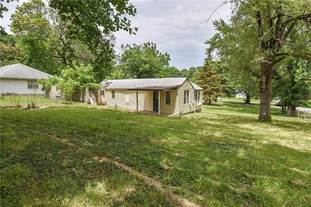 10908 E 66th St, Raytown, MO 64133 - rear view of house with a lawn