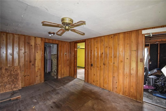 10908 E 66th St, Raytown, MO 64133 - spare room featuring a ceiling fan, wooden walls, and wood finished floors