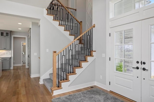 22112 W 80th Ter, Shawnee, KS 66220 - entryway featuring wood finished floors, stairs, baseboards, recessed lighting, and a towering ceiling