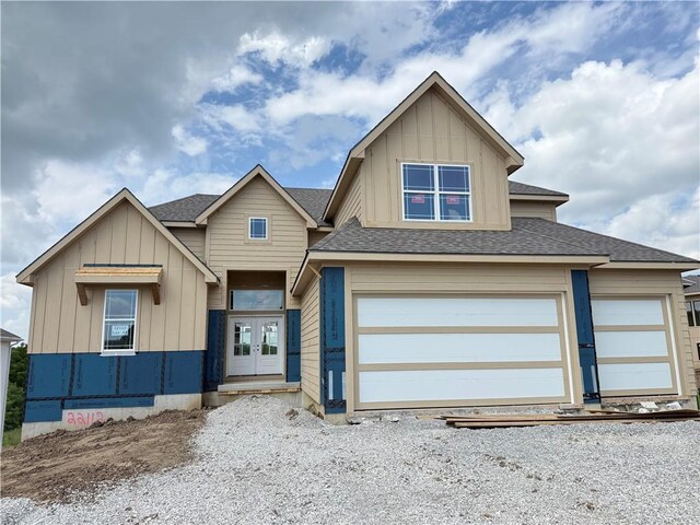 22112 W 80th Ter, Shawnee, KS 66220 - view of front facade featuring board and batten siding, a shingled roof, and french doors