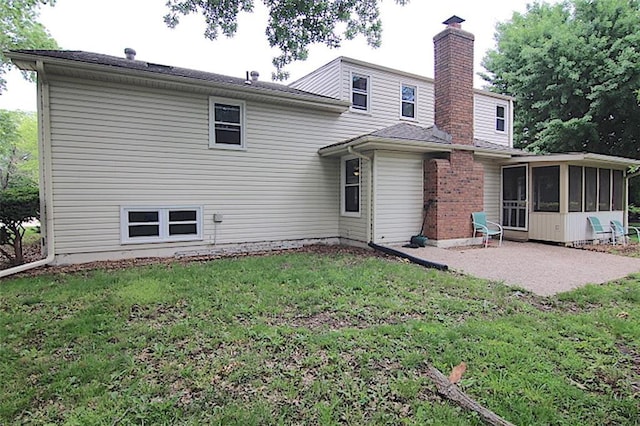515 Mulberry St, Lees Summit, MO 64086 - rear view of property featuring a sunroom, a chimney, a patio, and a lawn