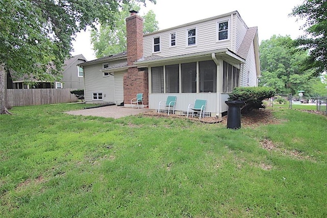 515 Mulberry St, Lees Summit, MO 64086 - rear view of house featuring a chimney, a sunroom, and a patio