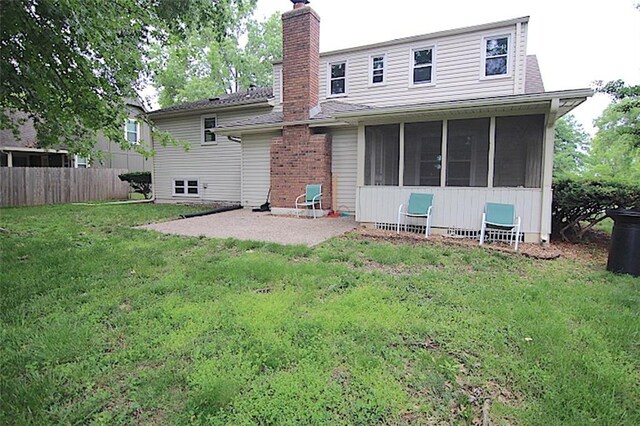515 Mulberry St, Lees Summit, MO 64086 - back of house with a sunroom, a chimney, and a patio area