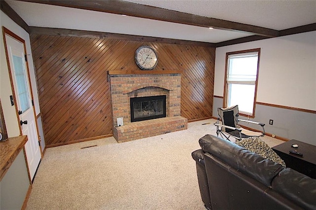 515 Mulberry St, Lees Summit, MO 64086 - living area featuring beamed ceiling, baseboards, a brick fireplace, wooden walls, and carpet