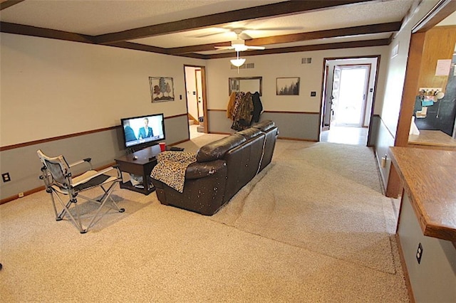 515 Mulberry St, Lees Summit, MO 64086 - carpeted living area with beam ceiling, ceiling fan, and baseboards