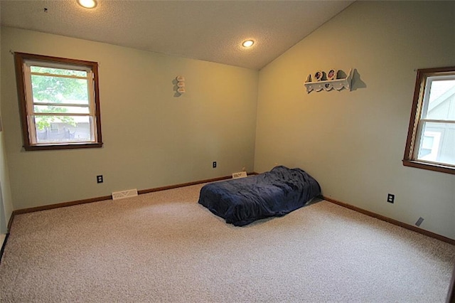 515 Mulberry St, Lees Summit, MO 64086 - carpeted bedroom featuring lofted ceiling, baseboards, recessed lighting, and a textured ceiling