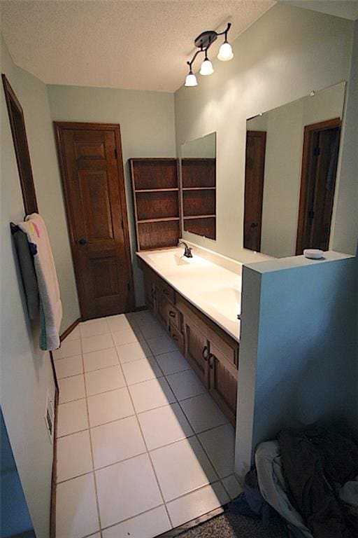 515 Mulberry St, Lees Summit, MO 64086 - bathroom featuring double vanity, tile patterned floors, and a textured ceiling