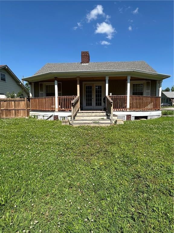 112 W Neosho St, Iola, KS 66749 - back of property featuring a chimney, french doors, and covered porch