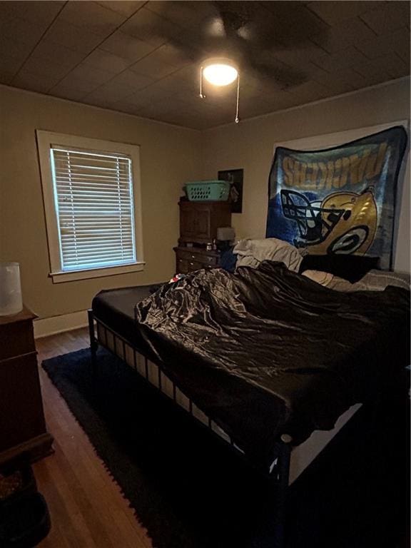 112 W Neosho St, Iola, KS 66749 - bedroom with wood finished floors and a ceiling fan