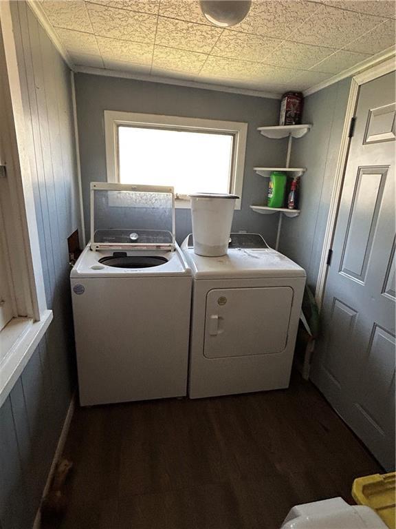 112 W Neosho St, Iola, KS 66749 - laundry room featuring separate washer and dryer, dark wood finished floors, ornamental molding, and wood walls