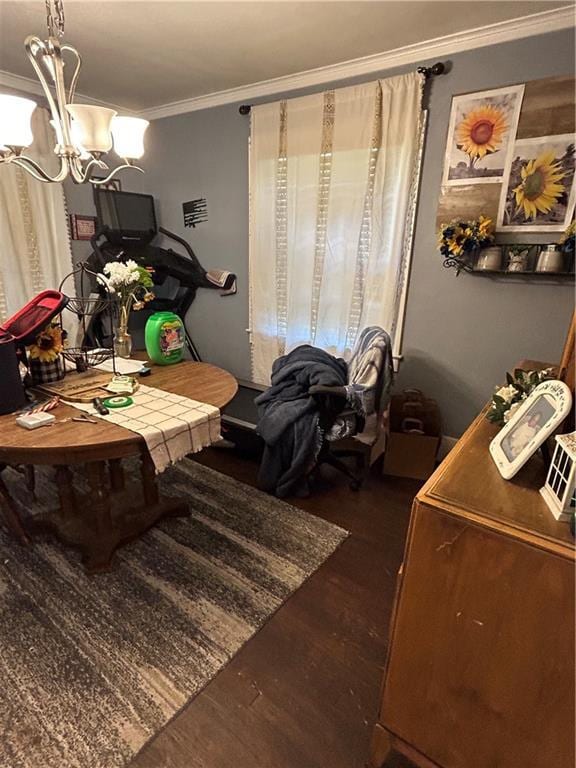 112 W Neosho St, Iola, KS 66749 - dining area featuring dark wood-type flooring, ornamental molding, and a chandelier
