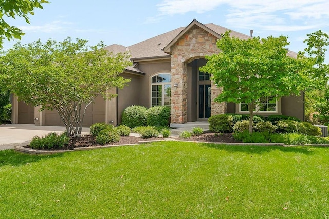 24793 W 98th St, Lenexa, KS 66227 - view of front facade featuring stone siding, driveway, a front yard, and a garage