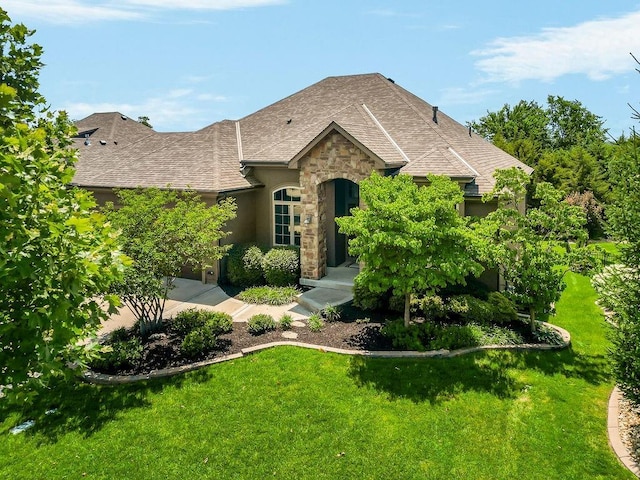 24793 W 98th St, Lenexa, KS 66227 - view of front of home featuring stone siding, a front lawn, and a shingled roof