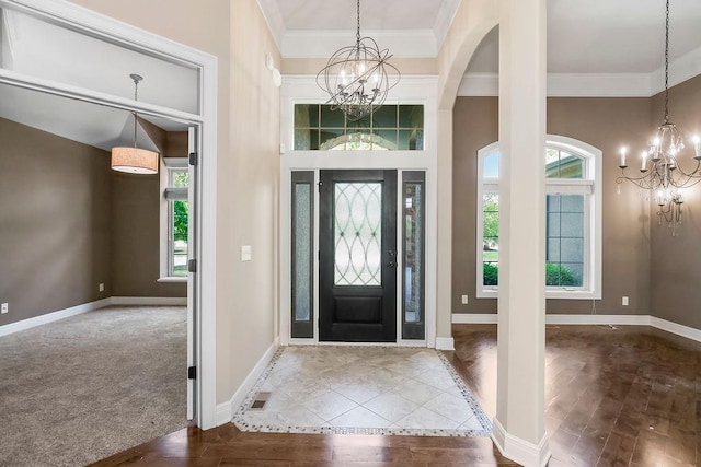 24793 W 98th St, Lenexa, KS 66227 - entryway with a chandelier, healthy amount of natural light, ornamental molding, wood finished floors, and a towering ceiling