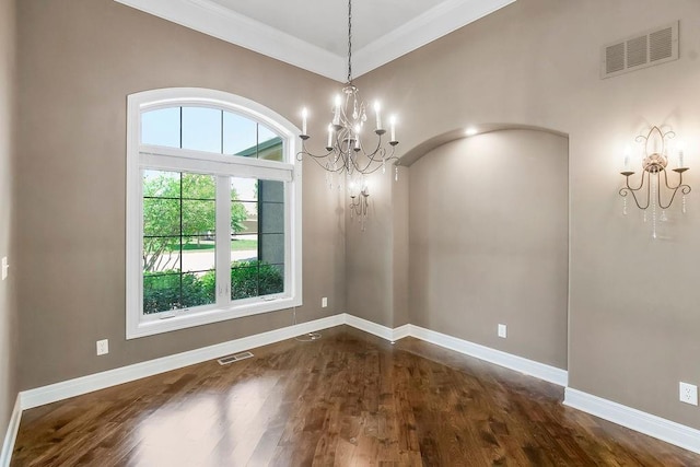 24793 W 98th St, Lenexa, KS 66227 - unfurnished room with a chandelier, dark wood-style floors, and ornamental molding